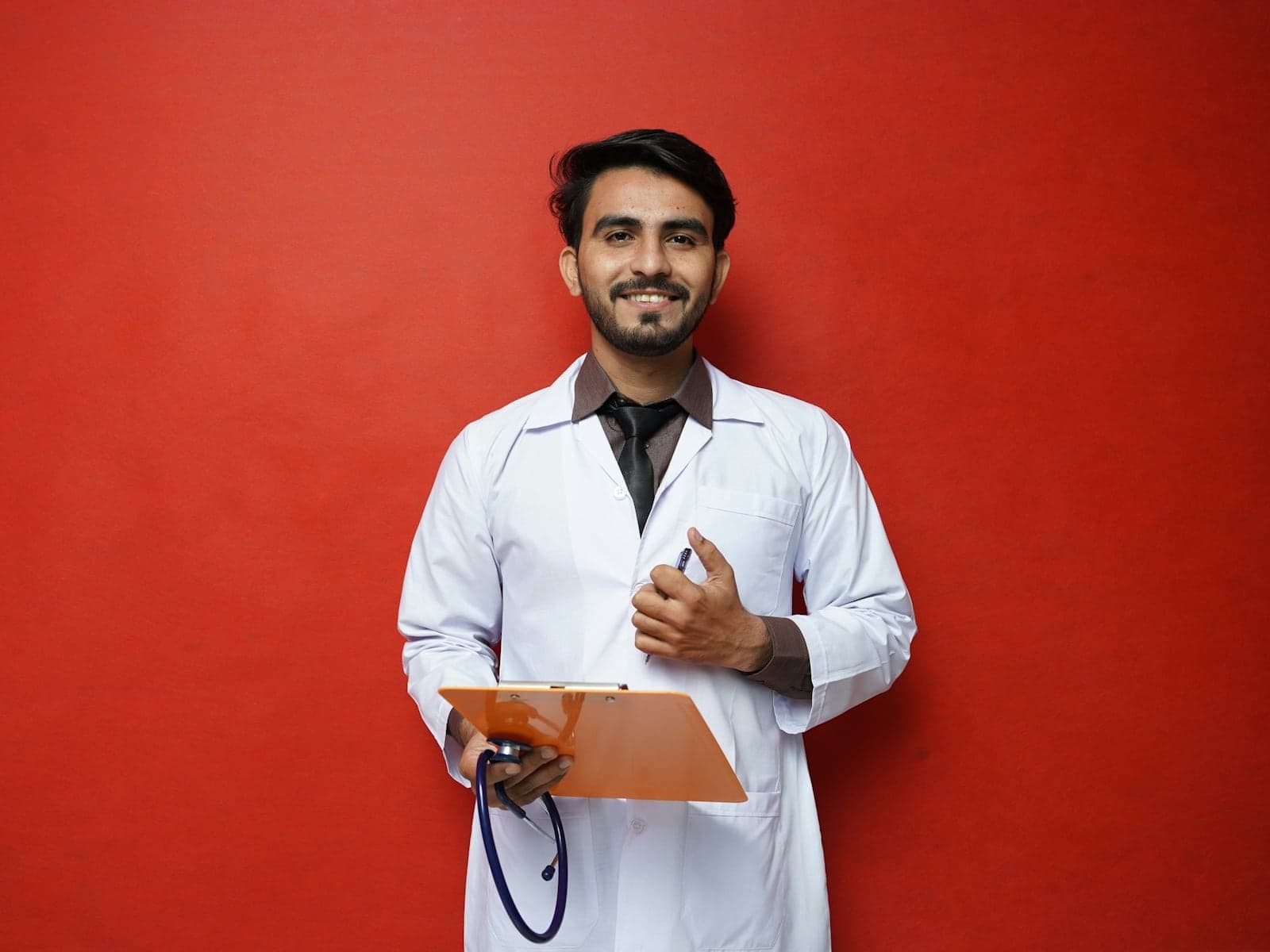 Smiling male healthcare worker in a white coat