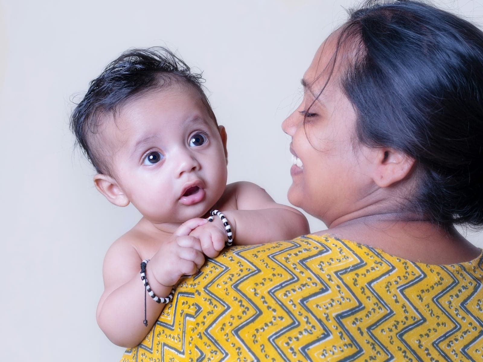 Caretaker holding a smiling baby